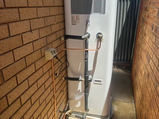 Split-system air conditioner condenser installed in a side yard