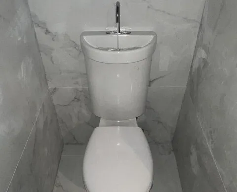 Finished marble-look bathroom with a wall-faced toilet suite
